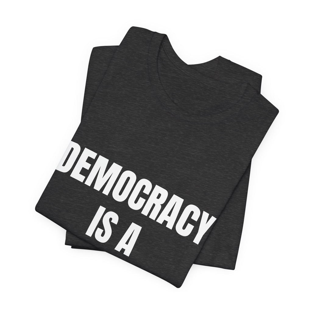 T-shirt reading “Democracy Is a Verb” in white block lettering