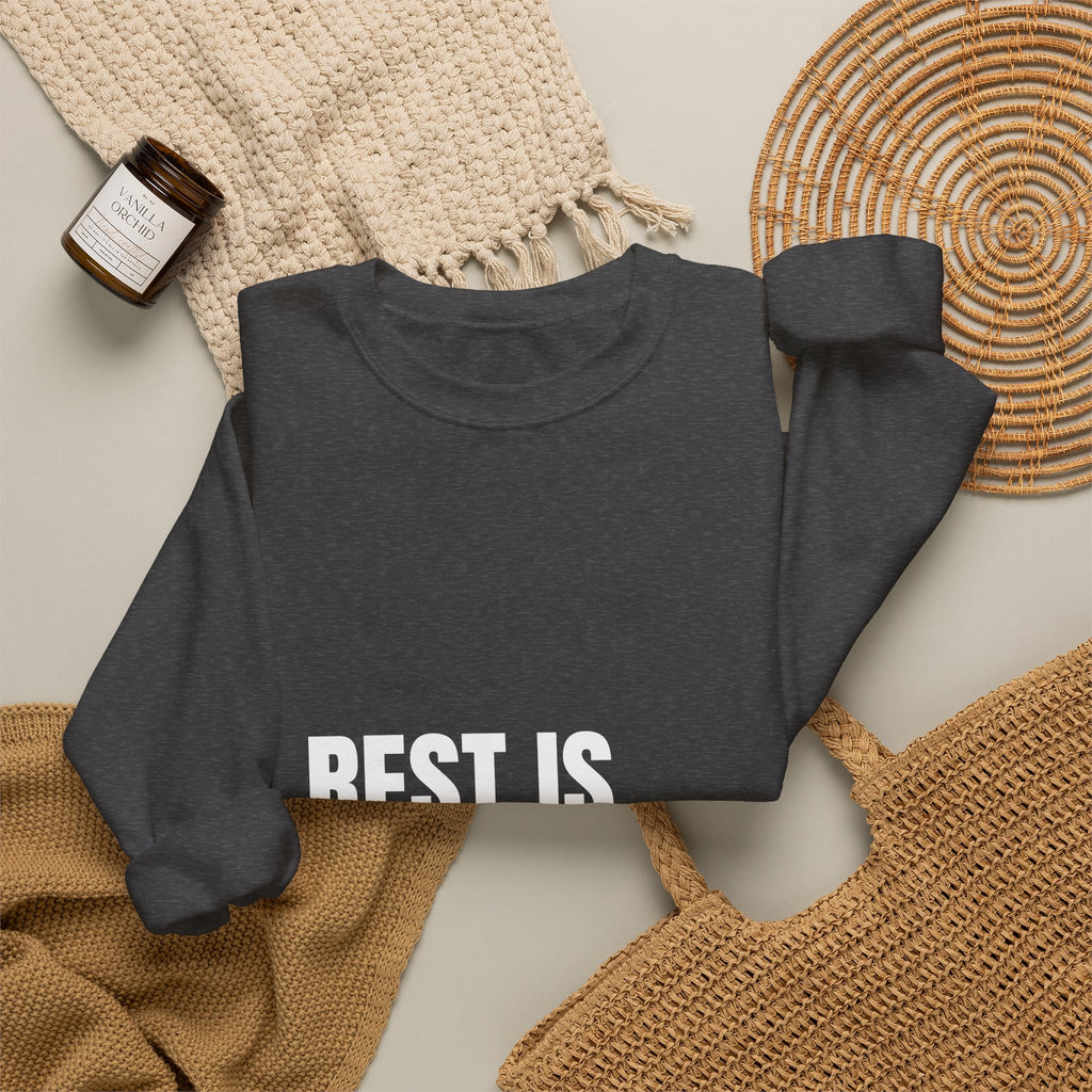 Crewneck sweatshirt reading “Rest Is Not a Reward” in white block lettering